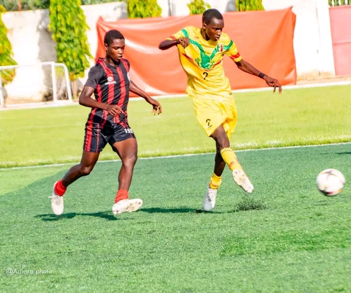 Mali based Edison Bwire in black and white contesting for a ball with an opponent 