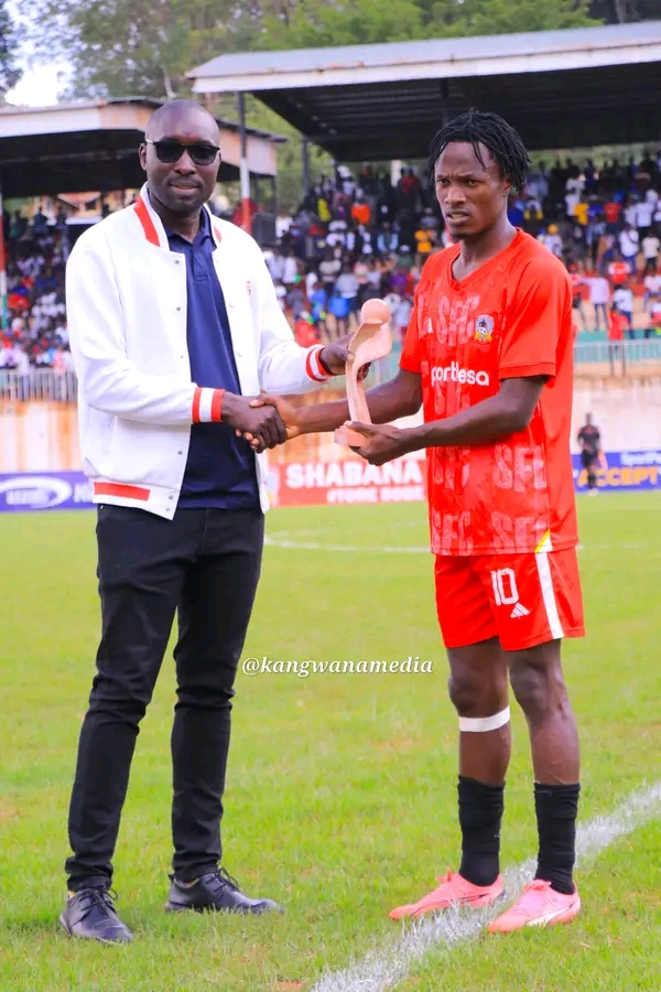 Brian Michira being presented with his Shabana Fc player of the month of November award 