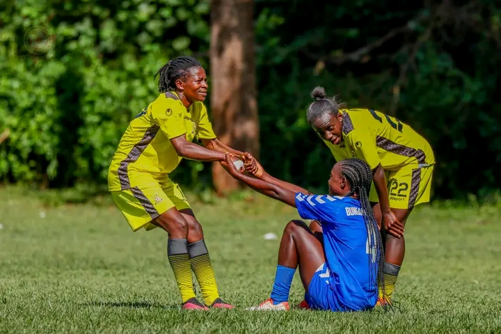 Police Bullets player helping a Bungoma Queens player back on her feet 